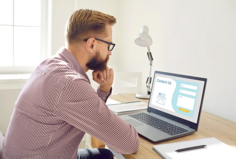 man at laptop on contact us page